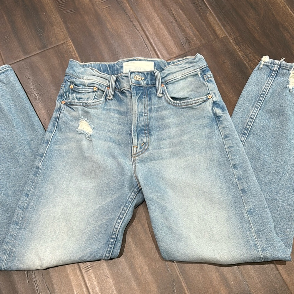MOTHER high rise jeans with some distress.